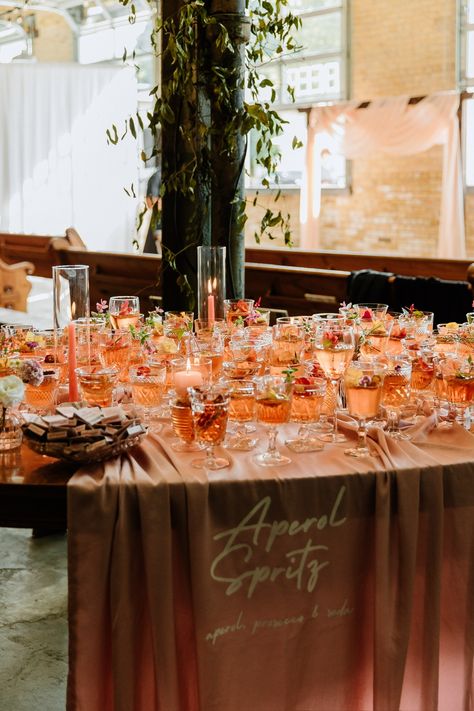 real wedding | signature cocktail | aperol spritz | modern wedding | wedding styling | bold wedding | Milwaukee | ceremony style | colorful wedding | floral design | signature drink | Aperol Spritz Wedding Theme, Aperol Wedding Bar, Wedding Aperol Spritz Bar, Aperol Spritz Tower Wedding, Apple Aperol Spritz, Cocktail Station, Italian Inspired Wedding, Signature Cocktails Wedding, Aperol Spritz