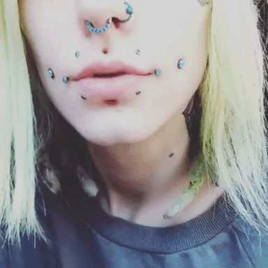 Unique Facial Piercings, Stretched Labret, Cheeks Piercing, Dahlia Piercing, Face Dermal Piercing, Pierced Girls, Face Dermal, Tongue Split, Nose Ring Men