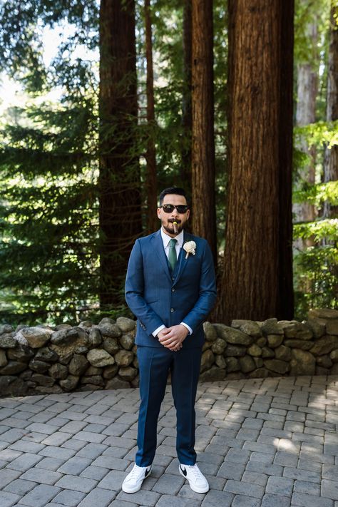 Make a statement on your big day with a fitted blue suit and trendy white sneakers. Plus, check out the eco-friendly solawood flower boutonniere. Groomsmen Attire Sneakers, Groom Suit With Sneakers, Groom With Sneakers, Suit And White Sneakers, Plus Size Groom, Trendy White Sneakers, Redwood Forest Wedding, Suits And Sneakers, Navy Blue Sneakers