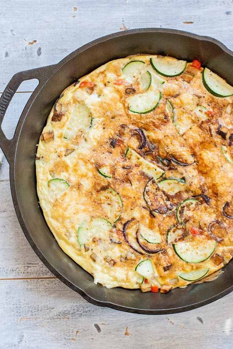 An easy frittata recipe using everyone’s favorite summer vegetable – zucchini. Some potatoes, red onion, and bell pepper round out the flavor, and parmesan cheese tops it off, cooked on the stovetop and then broiled until golden brown. The perfect way to start a summer weekend. Get the recipe now on Foodal. #friatta #zucchini #eggbake Potato And Zucchini, Zucchini Frittata Recipe, Easy Frittata Recipe, Potato Zucchini, Easy Frittata, Zucchini Frittata, Frittata Recipes, Vegetarian Dinners, Meatless Meals