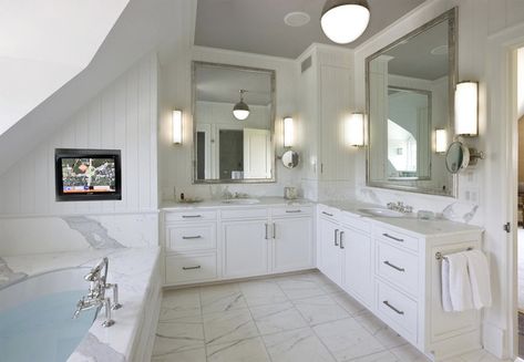 Stunning bathroom with built-in L-shaped white vanity featuring nickel hardware and marble counters. L Shaped Vanity Bathroom, L Shaped Bathroom Vanity, L Shaped Vanity, Bathroom Vanity Trends, L Shaped Bathroom, Beautiful Bathroom Vanity, Tv In Bathroom, Bathroom Vanity Designs, Stunning Bathrooms