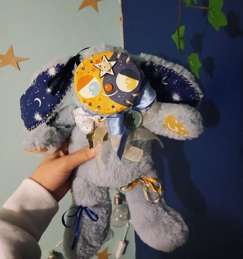 Image shows a customised blue-grey rabbit plush with a sewn-on clay face, which is painted to look like a moon. Star Stuffed Animal, Clown Clay Face Bear, Clay Stuffed Animal Face, Two Headed Plush, Plush With Clay Face, Stuffed Animal With Clay Face, Clay Face Plushies Clown, Clay Plush Face, Antibear Aesthetic