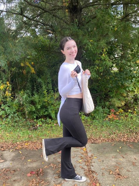 Wearing a ballet core style outfit today cropped white open back wrap top tied in a bow in the back. Black flare leggings both pieces from popflex active. Hair in clean girl style low bun with a ballet pink silk satin scrunchie and small gold hoops. Vintage style vogue tote bag. Black converse high top sneakers and a canon vlog camera Leggings And Converse, Black Flared Leggings, Black High Top Converse, Jeans And Converse, Black Converse, Flared Leggings, Black Flare, Outfits With Converse, Flare Leggings