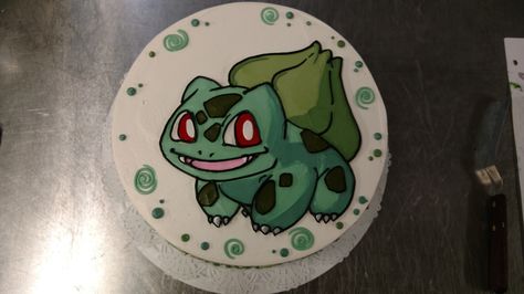 A ten inch Pokemon cake wtih a hand illustrated Bulbasaur. Bulbasaur Cupcakes, Bulbasaur Birthday Cake, Bulbasaur Cake Ideas, Bulbasaur Cake, Bulbasaur Birthday, Pokémon Cakes, Pokemon Cakes, Jesus Ideas, Buddha Birthday