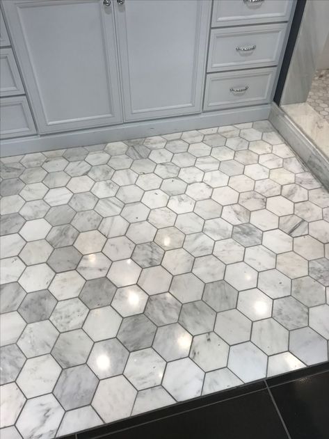 Love this grey with the darker grout. Hexagon floor tile in bathroom #hexagon Grey Marble Hexagon Tile Bathroom, Marble Tile With Dark Grout, Marble Tile Dark Grout, Bathroom Tile With Dark Grout, Bathroom Tile And Floor Combinations, Bathroom Tile Floor Ideas Master Baths, Bathroom Tile Ideas Farmhouse, Grey Marble Tile Bathroom, Honeycomb Flooring