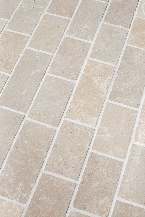 The timeless Dijon tumbled limestone in a wonderful outdoor stone cobble. This neutral toned stone complements an array of colour schemes with its soft beige and light grey hues. The mineral and fossil detail evident in this stone, make it a forgiving choice for both interior and exterior applications. The Dijon cobbles are in a 150 x FL format, creating a timeless and classic feel for outside areas. Dijon limestone is also stocked in an interior large format tile. Outdoor Stone Tiles, Montenegro House, Herringbone Tiles, Porcelain Pavers, Limestone Paving, Brick Laying, Tiled Hallway, Indoor Tile, Victorian Tiles