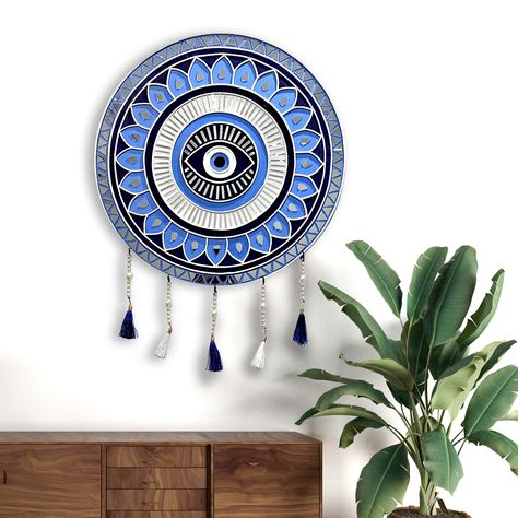 Kalaarang's Evil Eye Wall Piece: A Touch of Mystery In Hinduism, the evil eye concept is strong, and the symbol is used in various ways for protection. Symbolism: The evil eye itself is called "Drishti" (दृष्टि) or "Nazar" (नज़र) and is depicted as a single eye within a circle. Sometimes, it's embellished with concentric circles or a teardrop shape. Protection: Hindus believe the evil eye can cause misfortune due to envy or admiration. To ward this off, the evil eye symbol itself is used as ... Evil Eye Lippan Art, Evil Eyes, Evil Eye Art, Devil Eye, Eye Symbol, Art Diary, Eye Art, Circle Shape, Eye Drawing