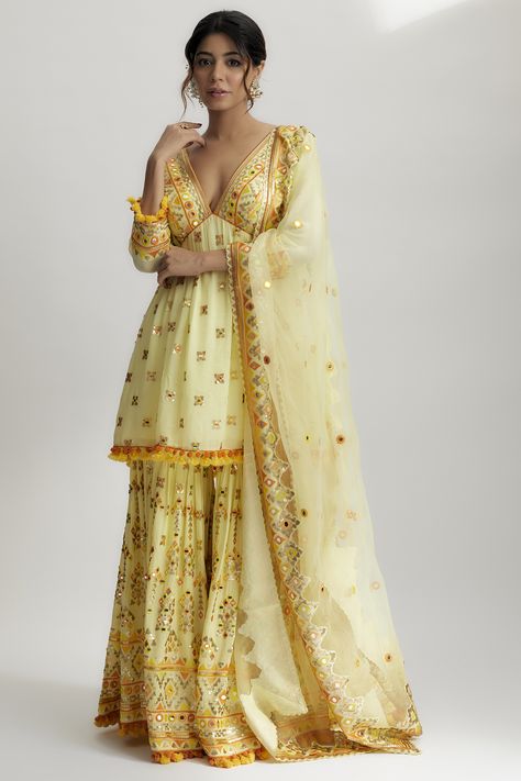 Featuring a yellow peplum kurta in georgette base with sequins hand and machine embroidery. It is paired with sharara pants and an organza dupatta. Perfect wear for a wedding or engagement ceremony. #perniaspopupshop #whatiworewastrending #ppuslove #gopivaid #festivewear #yellowhandembroideredsharara #sharara #shararaset #embroideredsharara #yellowsharara Peplum With Sharara, Indian Poses, Gopi Vaid, Embroidered Sharara, Sharara Designs, Sharara Pants, Girls Attire, Lehenga Designs Simple, Engagement Ceremony