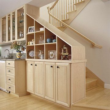 Storage with the Stairs-Built-in shelving is a practical and visually appealing way to display personal items or hide other items inside cabinets. Here, the maple cabinetry fits in beautifully with the floors and railings. Slanting downwards with the stairs, the look is both unique and sleek. Obtain a similar look by finding what finish would look best with your home decor. Basement Stairway Ideas, Basement Stairway, Basement Staircase, Basement Stairs Ideas, Entrance Ideas, Staircase Wall, Basement Storage, Basement Stairs, Stair Case