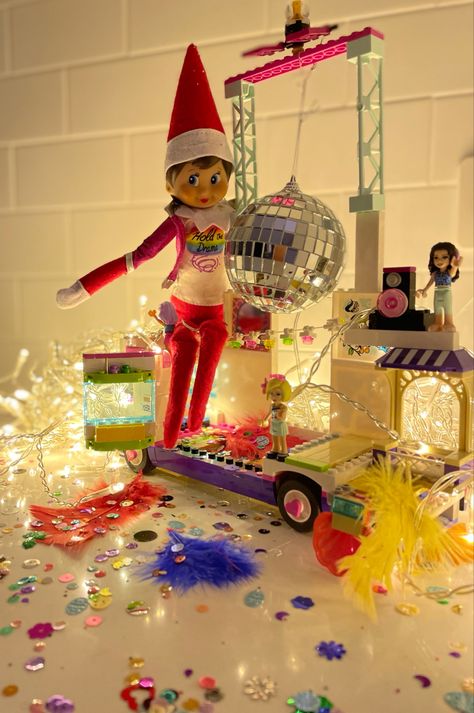 Lego Sparkles Feathers Small diaxo ball Fairy lights Elf Barbie Jacket #elfontheshelf #elfontheshelfideas Elf On The Shelf Ball Pit, Barbie Elf On A Shelf, Elf On The Shelf Disco Party, Elf On The Shelf With Barbie, Elf On The Shelf Barbie, Elf On The Shelf Party, Barbie Jacket, Elf 2024, Elf On Shelf