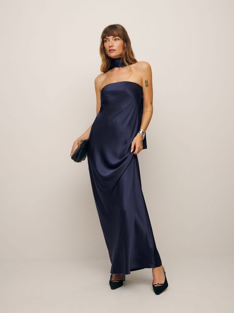 Don't flirt with me. The Oren is a strapless midi dress with a straight neckline, an A-line silhouette, and a matching scarf detail. Navy Blue Formal Dress With Shawl, Earthy Wedding Guest Dress, Dark Blue Bridesmaid Dresses Long, Fall Wedding Guest Dress Blue, Dark Purple Wedding Guest Dress, Dark Blue Silk Bridesmaid Dresses, Blue Marine Dress, Neutral Formal Dress, Navy Strapless Dress