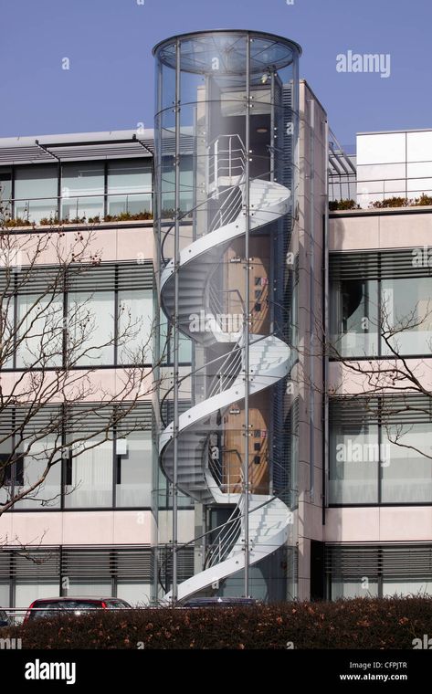 Download this stock image: Offices with enclosed external spiral staircase fire escape - CFPJTR from Alamy's library of millions of high resolution stock photos, illustrations and vectors. Spiral Staircase Ideas, Spiral Staircase Outdoor, Staircase Architecture, Stair Design Architecture, Spiral Stairs Design, Parking Building, Staircase Outdoor, External Staircase, Staircase Ideas