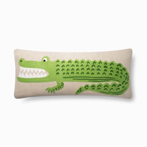 13" x 35" With its textured crewel embroidery and extra-large lumbar size, this Alligator Pillow pays homage Rifle Paper Co.'s native home of Florida. Perfect for kids' rooms or any other space that could use a new reptilian resident! The newest addition to the Rifle Paper Co. x Loloi collaboration. In collaboration with home decor brand Loloi, lifestyle brand Rifle Paper Co. brings you their newest collection of rugs and pillows for your home. A Dallas-based company and industry leader since 2 Loloi Pillows, Kid Rooms, Natural Pillows, Loloi Rugs, Crewel Embroidery, Pillow Collection, Bold Stripes, Pillows And Throws, Embroidered Pillow