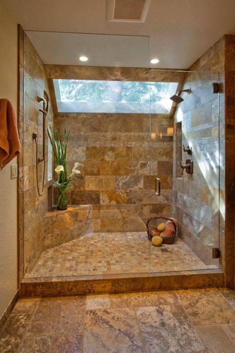 This breathtaking shower achieves an effortlessly elegant look. The neutral tile that covers the shower walls is echoed on the floor outside. The floor inside features smaller tiles, creating differentiation and visual interest. A large skylight and plant give the shower a natural, calming feel. Drømme Bad, Travertine Shower, Makeover Kamar Mandi, Bilik Air, Bathroom Shower Design, Rustic Bathroom Designs, Bad Inspiration, Rustic Bathrooms, Bathroom Remodel Shower