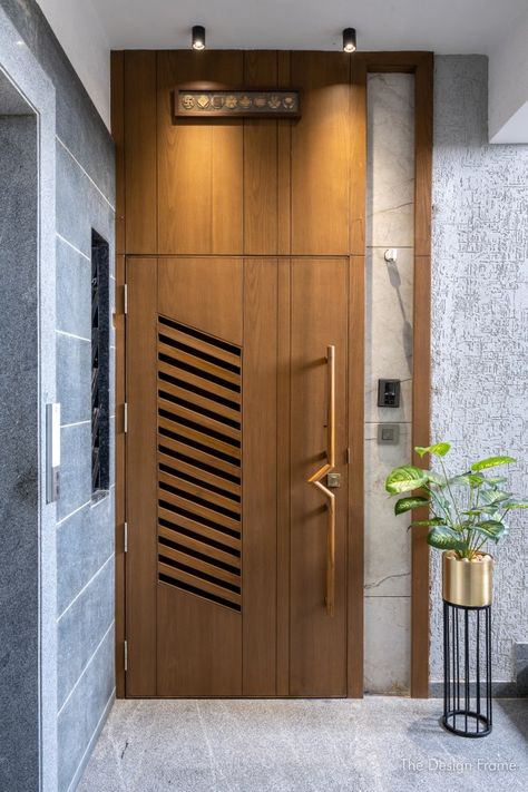 Elegant Apartment Space Designed With Ample Natural Light And Ventilation | The Design Frame - The Architects Diary Safety Door Handle Design, Door Design With Ventilation, Modern Door Frame Design, Main Door Lighting Ideas, Door With Ventilation Design, Main Door Design Modern Front Entry Wood, Flat Gate Design Modern, Sefti Door Design Modern, Wooden Safety Door Design