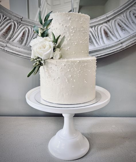 Wedding Cake Ideas Elegant 2 Tier, Simple White Wedding Cake Pearls, Clean White Wedding Cake, White Wedding Cake Texture, Peal Wedding Cakes, Two Tier Wedding Cakes Simple Classy, Winter Wedding Cake 2 Tier, White Cake Wedding Elegant, Engagement Cake With Pearls