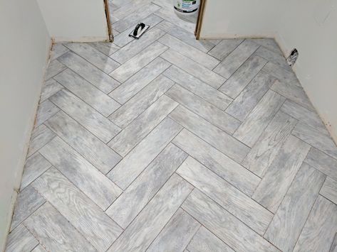 Bathroom flooring? Dapple grey wood look herringbone tile. Would need to keep everything else simple Olive Fireplace, Grey Wood Tile Floor, Gray Wood Tile Flooring, Wood Tile Floor Kitchen, Wood Tile Floor, Black And White Bathroom Floor, Wood Tile Bathroom Floor, Grey Wood Tile, Wood Tile Bathroom