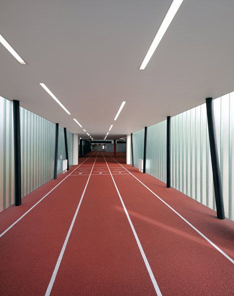 To create a full-length running track inside this refurbished gym in the Czech Republic, Prague studio QARTA Architektura added a translucent extension that projects out on stilts. Sports Pavilion, Aje Athletica, Athletics Track, Indoor Track, Floor Pattern, Colour Photo, Gym Interior, Community Centre, Running Track