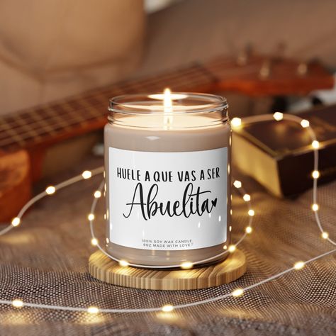 "Funny Grandma Spanish Pregnancy, Reveal Candle for Abuela - Abuelita Spanish Anuncio de Embarazo para Abuela Huele a Que Vas a Ser Abuelita  Packed with immersive aromas, these scented candles come in 9oz glass jars and are one size (2.8″ × 3.5\") (7.1cm × 8.8cm). Made with 100% natural soy wax blend, each candle features a 100% cotton wick and a permanent adhesive label where your custom designs can come alive. .: Materials: 100% natural soy wax blend, 100% cotton wick and a glass jar .: One size: 2.8″ × 3.5\" (7.1cm × 8.9cm) .: Burning time: 50-60 hours .: Glossy permanent adhesive label .: Choose from five different aromatic scents .: Assembled in the USA from globally sourced parts .: NB! All scents have the same wax color" Spanish Pregnancy Announcement, Funny Grandma, Unisex Baby Shower, Grandpa Funny, Family Diy, Pregnancy Reveal, Reveal Ideas, Baby Reveal