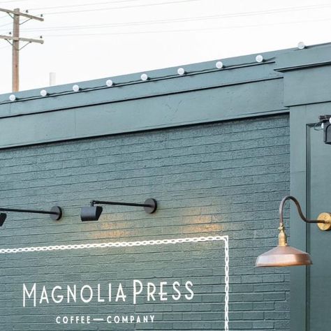 magnolia on Instagram: "When @joannagaines was designing Magnolia Press, she knew she wanted a moody, dark green color. This shade balances depth and sophistication with familiarity and comfort—the perfect backdrop for sipping a cup of coffee. Paint color: 1905 Green. Shop the entire collection on magnolia.com or at your local Ace Hardware. #MagnoliaHomePaint (crafted by @kilzbrand) #VisitMagnolia" 1905 Green Paint Magnolia, Magnolia Homes Paint, Magnolia Paint, Retail Facade, Coffee Nook, Outdoor Paint, Magnolia Homes, Painted Brick, Ace Hardware