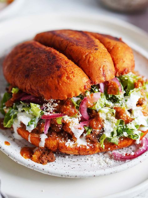 Pambazos are a mouth watering Mexican sandwich stuffed with a mixture of potatoes and chorizo, lettuce, crumbled queso & crema. The bread is covered in a delicious guajillo salsa and crisped to perfection. Irresistible! Guajillo Salsa, Potatoes And Chorizo, Mexican Sandwich, Chorizo And Potato, Mexican Menu, Mexican Chorizo, Mexican Side Dishes, Hot Sandwich, Hispanic Food