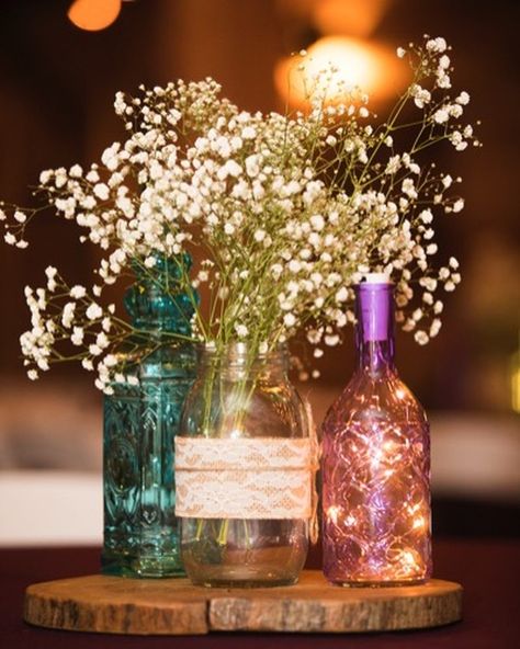 Fairy lights and baby's breath compliment each other so well.  #hollowhill #hollowhilldetails #weddingcenterpieces #rusticwedding #weatherfordwedding #fallwedding Bottle With Lights Centerpiece, Fairy Light Bottle Centerpiece, Bottle Lights Ideas Diy Projects, Fairy Lights In A Jar, Backyard Dinner, Weatherford Texas, Fairy Lights Wedding, 60th Bday, Wedding Centrepiece