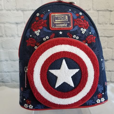 New To Poshmark Use My Code Sugarpixiespond During Sign Up To Save $10 On Your First Purchase! Loungefly Marvel Captain America 80th Anniversary Mini Backpack. Base Of The Bag Is Blue Denim. It Has Red Vegan Leather Straps Handle Zipper Trim And Interior. Circular Front Pocket Has Chenille Material Making The Ringed Red White And Blue Star Centered Shield Cap Carried In Avengers. There Are Embroidered Rose Floral Flowers Around The Sides With Blue Leafy Foliage Sporadically Placed. Small White F Marvel Items, Marvel Merch, Marvel Backpack, Winnie The Pooh Honey, Stitch Backpack, Sequin Backpack, Disney Pixar Up, Star Wars Droids, Embroidered Rose