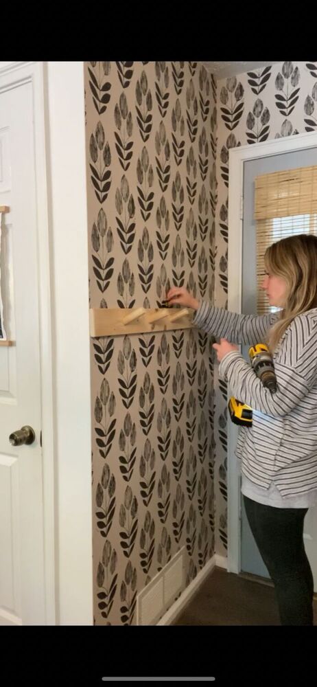 The perfect simple rack for a small entry way does exist! I recently wallpapered this small garage entryway and had taken down my old clunky coat rack.I wanted something sleek, modern, and low profile and this fit the bill perfectly. 1. Measure First, you want to measure your space. 2. Cut board and sand. Cut board to desired length and sand smooth. 3. Cut dowel rod. Cut dowel rods at a 30 degree angle, about 3 inches long. You totally don’t have to do these at an angle. They can… Small Entry Way, Garage Entryway, Hanging Wine Glass Rack, Easy Fall Wreaths, Small Garage, Wallpaper Stores, Beautiful Dresser, Small Entry, Diy Nightstand