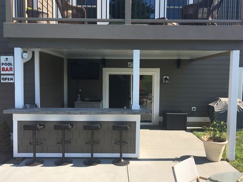 Built this bar under the deck and installed a underdeck roof. In the summers, this is our own Key West! Outdoor Bar Ideas Under Deck, Under Deck Tv Ideas, Built In Deck Bar, Outdoor Bar Under Gazebo, Outdoor Bar Under Deck, Under Deck Bar Ideas, Under Deck Bar, Outdoor Kitchen Under Deck, Bar Under Deck