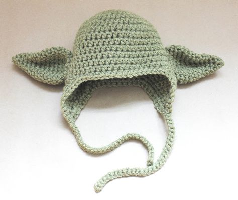 I received an e-mail the other day from someone who asked if I could crochet a Yoda hat for a baby who is due any day to some die-hard Star Wars fans. I was up for the challenge and came up with this cute little earflap beanie with Yoda ears :o)  I can’t re-post the … Crochet Yoda Hat, Yoda Crochet Hats, Baby Yoda Hat, Yoda Hat, Star Wars Crochet, Crochet Costumes, Repeat Crafter Me, Hat Patterns Free, Confection Au Crochet