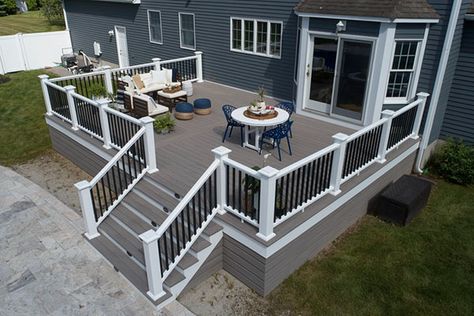 Deck Design Ideas to Spark Your Imagination | TimberTech Front Of Deck Landscaping, Beach House Deck Railing, Front Of House Deck Ideas, Blue House With Deck, Outdoor Deck Design Ideas, Trek Deck Ideas, Deck Ideas Off Back Of House, Front Deck Ideas, Wood Deck Ideas