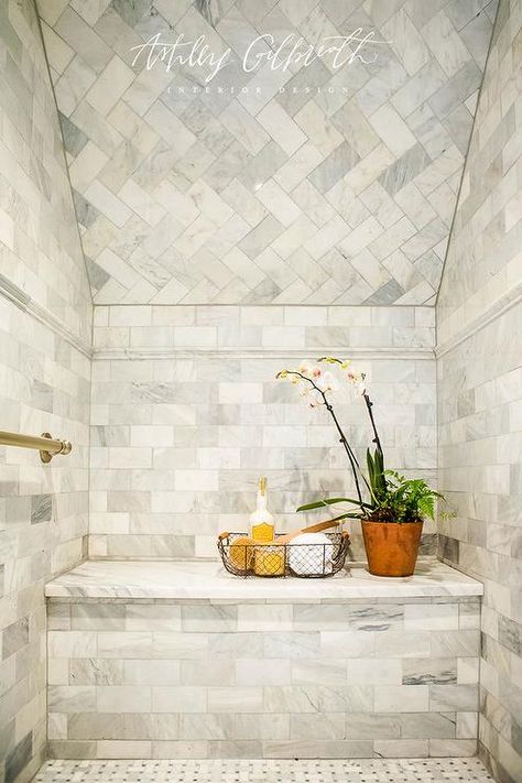 A sloped shower ceiling is decorated with marble herringbone tiles including a shower bench perfectly situated on basketweave floor tiles. Ashley Gilbreath Interiors, Ashley Gilbreath, Marble Herringbone Tile, How To Tile, Marble Herringbone, Attic Lighting, Attic Closet, Attic House, Friday Eve