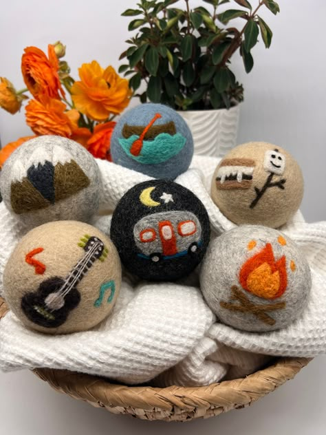 "Ditch the disposable dryer sheets for our Fluff Ewes \"Are we there yet?\" dryer balls! These road trip inspired cuties will add a dose of outdoor nostalgia to your loads, too.  Perfect for gifting to the outdoor enthusiast, road trip fanatic, nature lover, camping aficionado, hiking lover or rock climber in your circle.   - Natural fabric softener; reduces wrinkles and static - Chemical free, no fillers or synthetic ingredients--a rubber-free, petroleum-free alternative to tennis balls and plastic dryer steamer balls - Use only the safest, most natural dyes. Our practices are planted friendly, certified azo and lead-free.  - Decrease drying time by 20-40% (depending on load size) - Conserve energy (and save money on your utility bill!) - Eco-friendly; eliminates waste in landfills with t Needle Felting Dryer Balls, Felted Dryer Ball Designs, Needle Felted Dryer Balls, Felted Dryer Balls, Natural Fabric Softener, Essential Oils For Laundry, Felting Diy, Conserve Energy, Are We There Yet