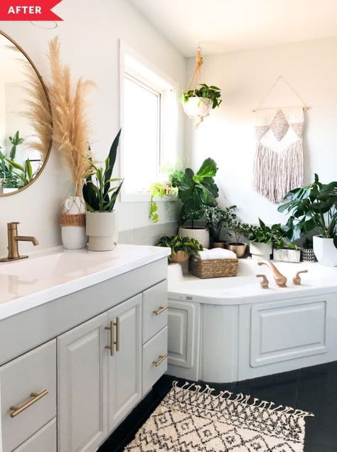 After: Bathroom with pale gray vanity, black floor, white walls Rental Bathroom, Old Bathrooms, White Tile Floor, Bathroom Plants, Garden Tub, Boho Bathroom, Bathroom Redo, Home Upgrades, House And Home Magazine