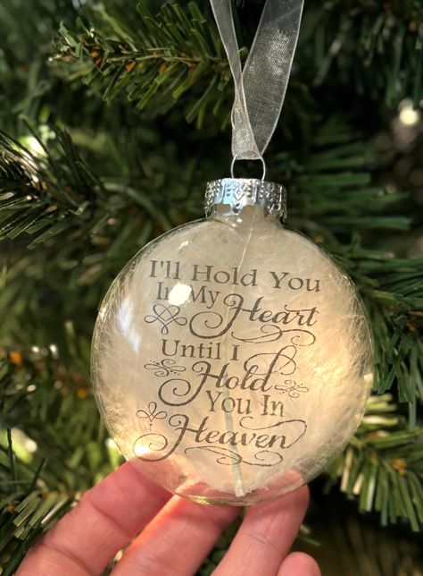 This is a round puffed flat glass ornament that measures approximately 3.15" in diameter, with a white feather behind a transparency with the words, "I'll hold you in my heart until I hold you in Heaven" on the inside of the ornament. The ornament hangs from white organza ribbon. Makes a beautiful memorial for your lost loved one. Comes in a small box for safe keeping. Quick link back our store's homepage: http://www.etsy.com/shop/HeartProjects?ref=pr_shop Find us on facebook for new listings an In Memory Christmas Ornaments, Mom Memorial, Dad In Heaven, Ornament Ideas, White Feather, Memorial Ornaments, Organza Ribbon, Glass Blocks, White Feathers