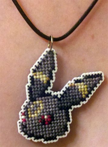 Umbreon head Pokemon Necklace, Stitch Games, Cross Stitch Necklace, Pokemon Cross Stitch, Beading Designs, Pokemon Perler Beads, Pokemon Craft, Perler Patterns, Alpha Patterns