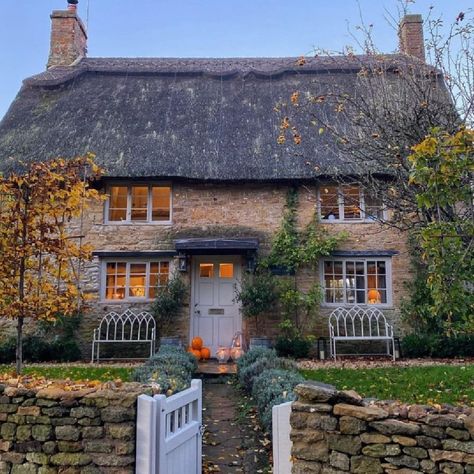 Osborn Interiors award winning English country cottage in the Cotswolds with thatched roof, stone walls, and a charming gate. #cotswoldcottage #englishcountry Cottagecore Pumpkin, English Cottage Exterior, Rosehill Cottage, Cozy Window Nook, Cotswold House, Cotswold Cottage, Pumpkin Garden, English Country Cottage, Garden Illustration