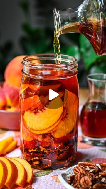 Lexi Harrison & Beth Sinclair on Instagram: "Peach Pecan Infused Bourbon 🍑🥃 We’ve been infusing different types of alcohol all summer long and to my surprise, this has been one of my absolute favorites! It’s a little sweet, perfectly peachy and slightly nutty, which adds so much depth of flavor to any summer cocktail. 

🍹We added ours to iced tea with some homemade peach syrup and it was perfection! It’s also incredible in a peach bourbon smash, or even just for sipping on its own.

Infusing is such a great way to capture the flavor of your favorite produce at its peak, and it’s SO easy to do. 

✍️Here’s what you need to make this infused bourbon: 

1/2 cup unsalted, toasted pecans  1 1/2 large (or 2 small) peaches, sliced 
1/2 cup pure maple syrup 
2-2 1/2 cups bourbon or whiskey 

Add Canned Bourbon Peaches, Moonshine Peaches, Rum Watermelon, Peach Pecan Infused Bourbon, Different Types Of Alcohol, Peach Infused Vodka, Peach Infused Whiskey, Types Of Alcohol, Infused Bourbon