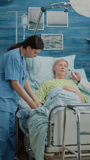 Premium Photo | Old woman with sickness getting consultation from nurse and doctor in nursing home. retired patient laying in hospital bed while medical team doing checkup visit for recovery examination In Hospital Bed, Health Ads, Happy Emotions, Couples Play, Feeling Excited, Hospital Bed, Digital Tablet, Positive People, In Hospital