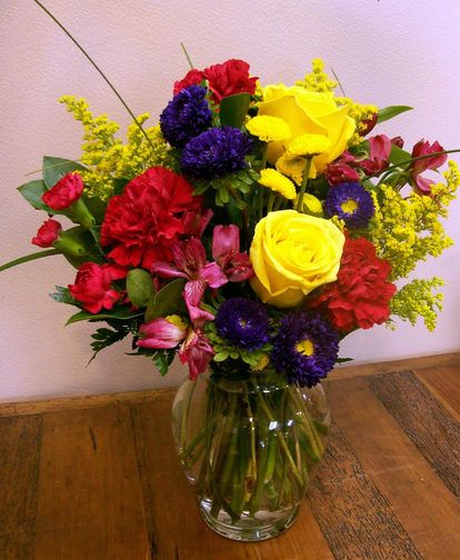 Brighten Your Day Bouquet-All the frills and every color under the sun, this fresh flower arrangement is ready to brighten your recipient's day! Yellow roses, purple  matsumoto asters, red carnations, and red mini carnations are accented with  lush greens to create a fascinating display. #CasasAdobesFlowerShop #TucsonFlowers #MardiGras #MardiGrasFlowers Red Yellow Purple Flower Arrangements, Red Flower Arrangements, Red And Purple Wedding, Purple Flower Arrangements, Fresh Flower Arrangement, Lego Flowers, Mini Carnations, Roses Purple, Purple Wedding Ideas