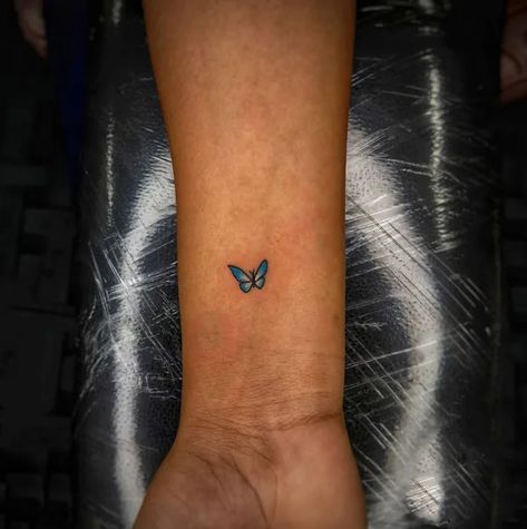 https://allabouttattoo.com/wp-content/uploads/2022/09/Small-blue-butterfly-tattoo.webp Blue Butterfly Tattoos For Women, Small Butterfly Tattoo Blue, Blue Tattoo Butterfly, Blue Minimalist Tattoo, Blue Butterfly Tattoo Ankle, Blue Buterfluffy Tattoo, Tiny Blue Butterfly Tattoo, Small Butterfly Tattoo Color, Blue Butterfly Tattoo Arm