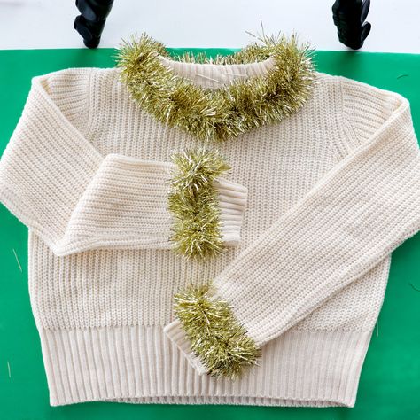 Gold Tinsel Cuff and Neckline Holiday Sweater | 5 DIY Temporary Christmas Sweater Party Outfit Ideas Diy Tinsel Sweater, Tinsel Outfit Diy, Christmas Sweater Party Outfit, Sweater Design Ideas, Sweater Party Outfit, Creative Ugly Christmas Sweater, Tinsel Sweater, Ugly Christmas Sweater Ornament, Christmas Sweater Design