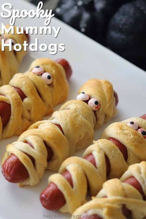 These Mummy Hot Dogs are an adorable Halloween dinner or party appetizer that couldn’t be easier. Made with crescent roll dough, they’re the perfect festive finger food that uses just a few basic ingredients. #thecarefreekitchen #halloween #partyappetizers #hotdogs #mummyhotdogs #kids #fingerfood #mummydogs Halloween Mini Weenies, Mummy Dogs Recipe, Halloween Hotdogs Fingers, Ghost Hotdogs, Hot Dogs Crescent Rolls Recipes, Christmas Hot Dogs For Kids, Mummy Wrapped Hotdogs, Mummy Dogs For Halloween, Hot Dog Mummies Crescent Rolls