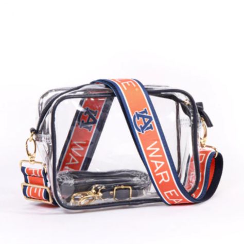 Trending Now! Game day style never looked so good, our new clear purse comes with 2 sets of straps! Change up your look between matching vegan leather or our new reversible patterned shoulder straps. What’s to love about the Bridget: Crafted of clear vinyl and soft vegan leather, featuring brass hardware accents Stadium Approved Sized at 8" x 6" x 2" Includes 2 adjustable purse straps for changing up your look in a snap Easily wipes clean zipper closure Purse Game, Clear Purses, Canvas Purse, Blue Purse, Auburn Tigers, Clear Bags, Purse Strap, Clear Vinyl, Cute Bags