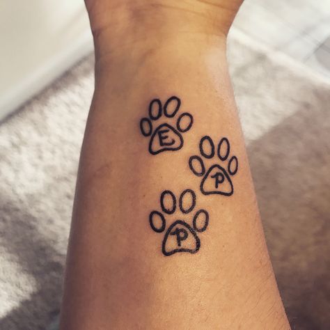 My first tattoo!!! Dedicated to my pets and leaves room to add more paw prints in the future :) Paw Print Tattoo Dog With Initial, Dog Paw With Initial Tattoo, Paw Print With Letter Tattoo, Paw Print Tattoo With Initial, Simple Paw Print Tattoo, Paw Prints Tatoos, Equality Tattoos, Tiny Paw Print, Tattoos 2024