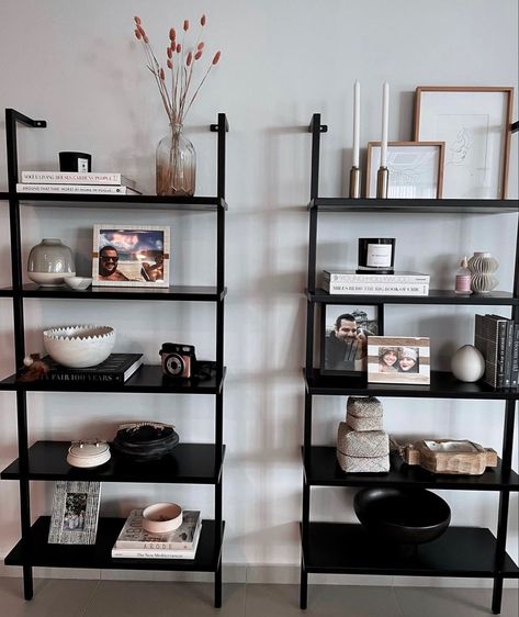 Black Bookshelf Decor Living Room, Books In Small Apartment, Cb2 Ladder Shelf, Vittsjo Entryway, Black Ladder Shelf Decor, Dark Shelf Decor, Ladder Bookshelf Styling, Ladder Bookshelf Decor, Standing Shelf Decor