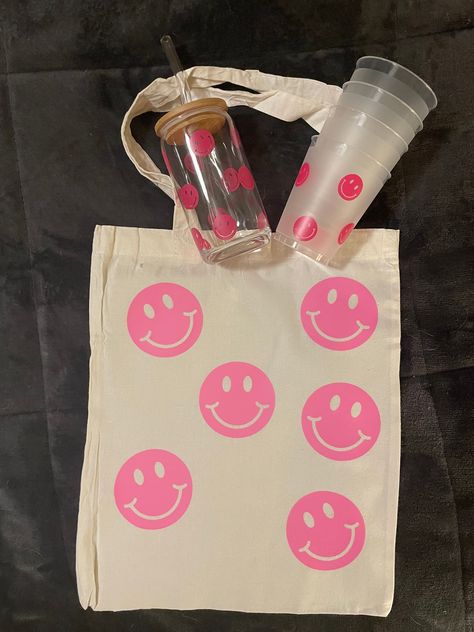 Smiley face preppy smiley canvas tote bag 13x15 book bag beach custom personalized tote cup tumblers glass cup you will receive 1 tote canvas bag 4 frosted plastic smiley 12oz cups 1 16oz smiley face glass cup tumbler personalized if wanted Day List, Cup Tumbler, Tumbler Personalized, Cute Preppy Outfits, Mini Tote Bag, Book Bag, Mini Tote, Personalize Bag, Preppy Outfits