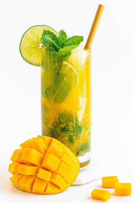 Love mangos? Love mojitos? If you said yes to both then this Mango Mojito recipe is the cocktail for you! A classic mojito with a fun tropical twist – this mango infused version is super refreshing and perfect for summer! It's also super easy to turn into a mocktail or a pitcher. | www.mapleandmango.com Mango Mojito Recipe, Mango Cocktail, Classic Mojito, Mango Drinks, Mango Mojito, Mojito Mocktail, Refreshing Summer Cocktails, Mojito Cocktail, Slice Of Lime