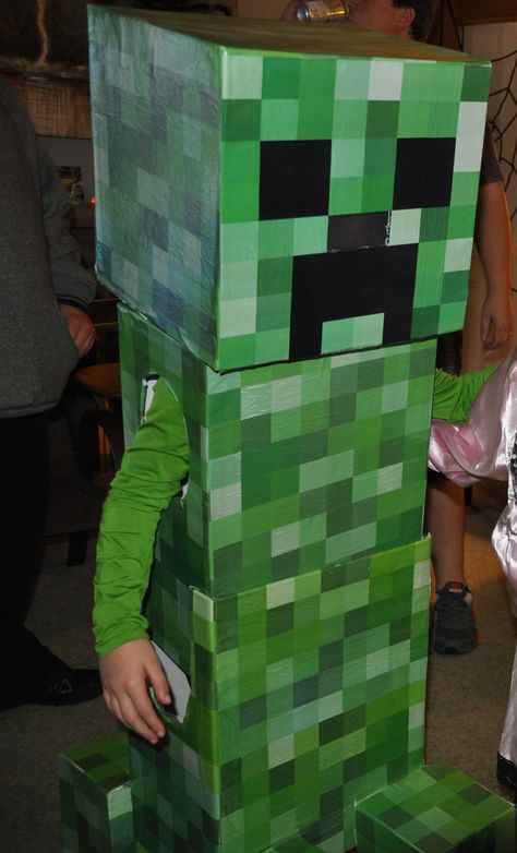 DIY Telescoping Minecraft Creeper Halloween costume we made. We modified the dimensions to fit our child based on this website that provided the idea and directions: http://www.instructables.com/id/Telescoping-Minecraft-Creeper-Costume. We used white foam board you can buy at home improvement stores like Home Depot or Lowes. Then we found a green creeper pattern and printed it on large sheets. Tape and Mod Podge glue were used to adhere the sheets to the foam board. It came out great! Minecraft Creeper Halloween Costume, Minecraft Halloween Costume, Creeper Costume, Creeper Outfit, Minecraft Costumes, Silhouette Gifts, Creeper Minecraft, Minecraft Steve, Diy Minecraft