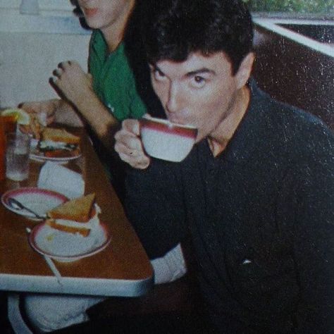 The image is of the musician David Byrne drinking a cup of coffee in a cafe. New Wave 80s, 70s Rock Music, They Grow Up So Fast, Breakfast Aesthetic, Dark Wave, David Byrne, Talking Heads, Music People, Music Icon